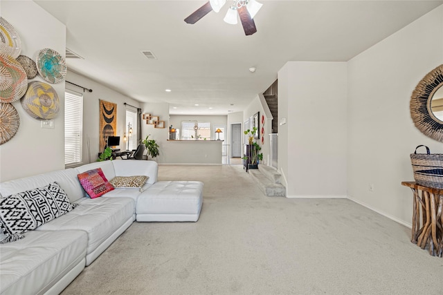 carpeted living area featuring visible vents, recessed lighting, a ceiling fan, and baseboards