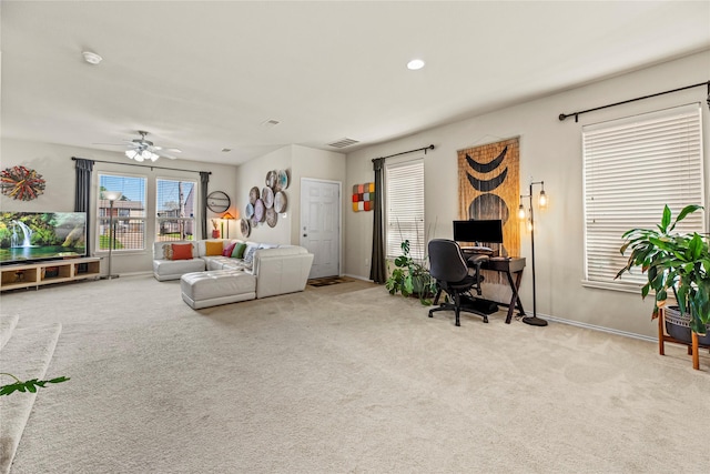 living room with visible vents, baseboards, and carpet floors