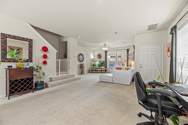 home office featuring visible vents, a ceiling fan, and carpet floors