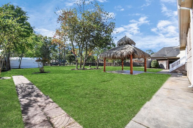 view of yard featuring a gazebo, fence, and a patio