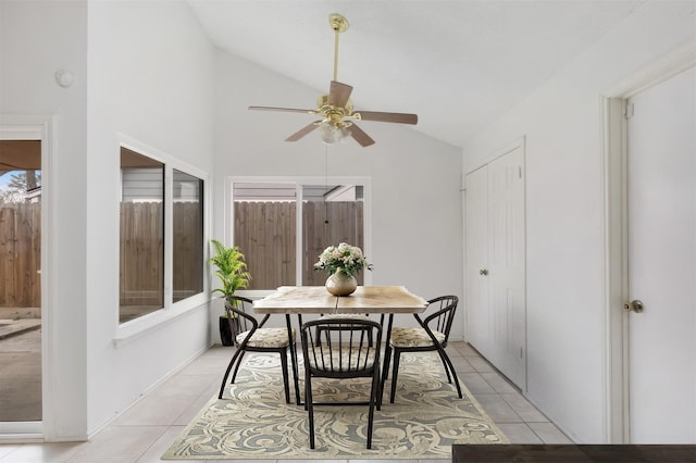 dining room with lofted ceiling, light tile patterned floors, and ceiling fan