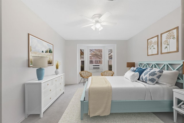 bedroom with light colored carpet, cooling unit, and a ceiling fan