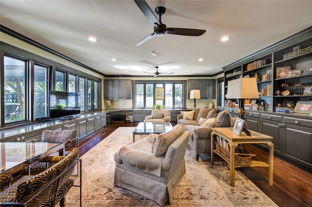 living room with ornamental molding, wood finished floors, and ceiling fan