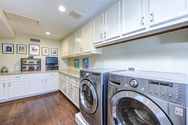 clothes washing area featuring cabinet space, dark wood-style floors, washing machine and dryer, and visible vents