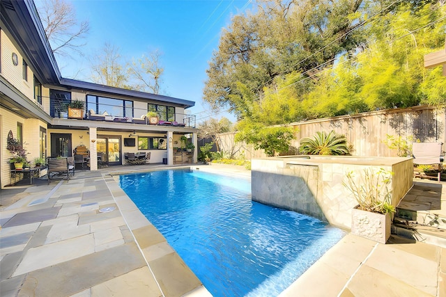 view of swimming pool featuring a fenced in pool, a patio, and a fenced backyard