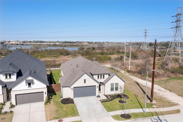 view of front of property with roof with shingles, concrete driveway, a front yard, and fence