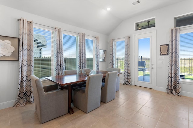 dining area featuring vaulted ceiling, light tile patterned floors, baseboards, and visible vents