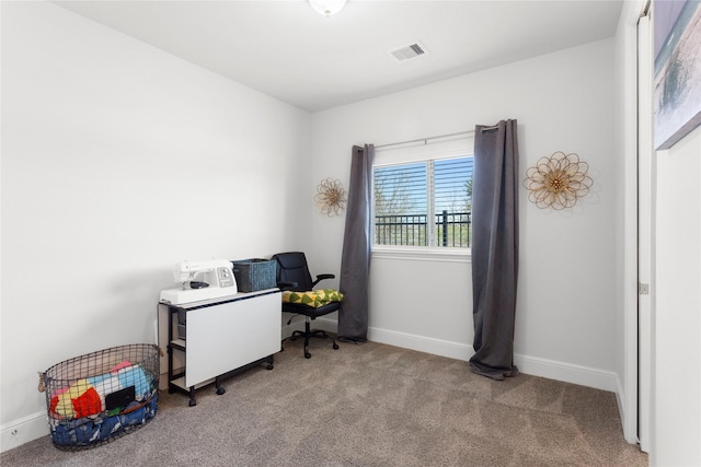 carpeted office space featuring baseboards and visible vents