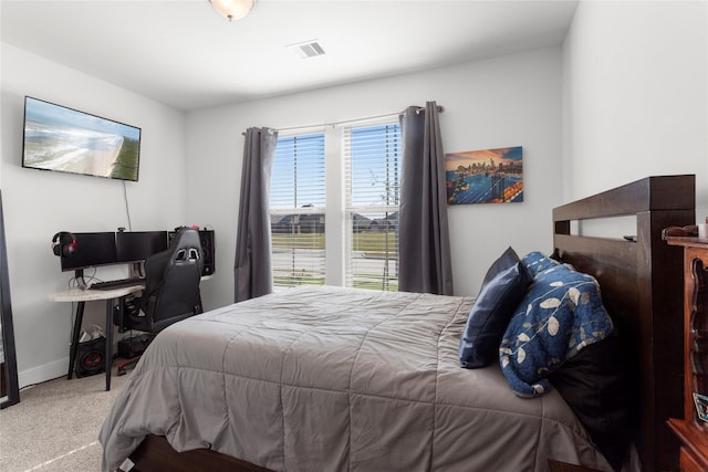 carpeted bedroom with visible vents and baseboards