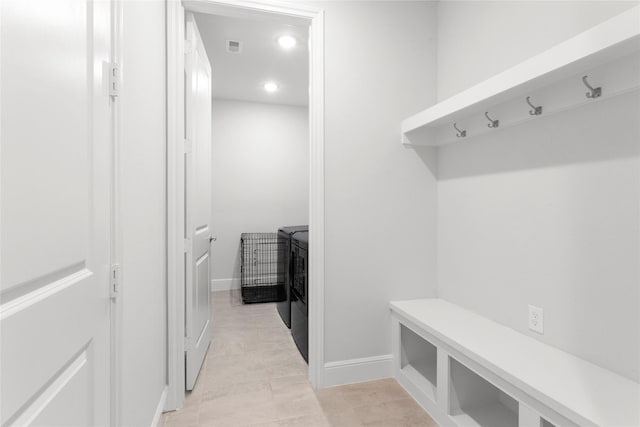 mudroom with recessed lighting, washing machine and dryer, visible vents, and baseboards