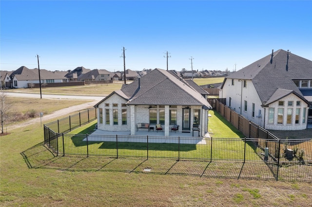 back of property with a patio area, a residential view, a yard, and a fenced backyard