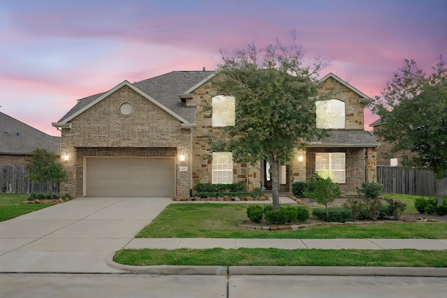 view of front of property featuring brick siding, a lawn, driveway, and fence