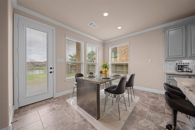 dining space featuring visible vents, baseboards, crown molding, and stone finish flooring