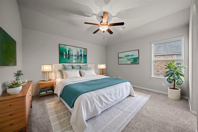 carpeted bedroom with a ceiling fan, vaulted ceiling, baseboards, and visible vents