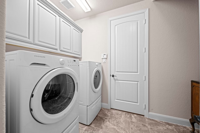 laundry area with cabinet space, visible vents, washer and dryer, and baseboards