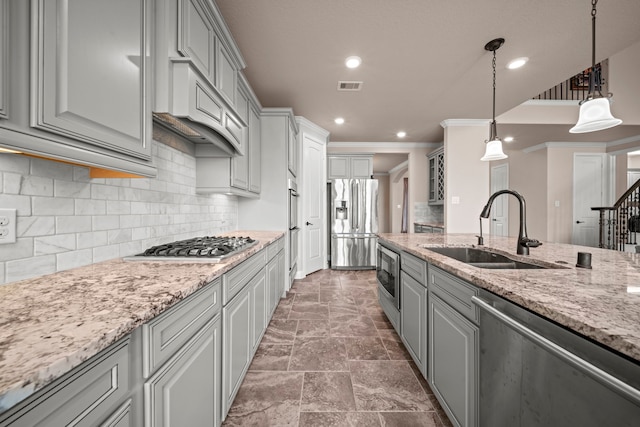 kitchen featuring visible vents, gray cabinetry, a sink, tasteful backsplash, and appliances with stainless steel finishes