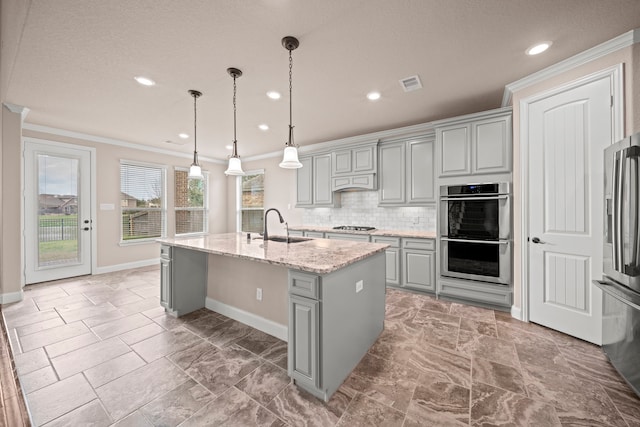 kitchen featuring visible vents, gray cabinetry, a sink, stainless steel appliances, and crown molding