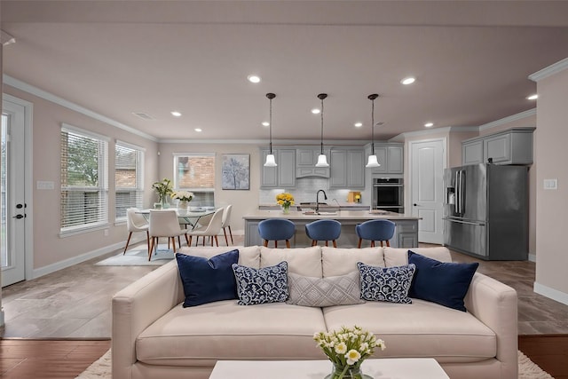 living room with recessed lighting, visible vents, and ornamental molding