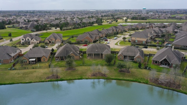 drone / aerial view featuring a residential view and a water view