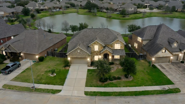 drone / aerial view with a residential view and a water view