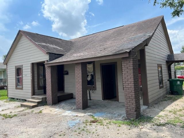 single story home with roof with shingles