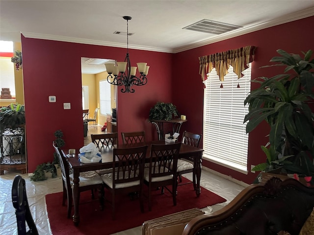 dining space featuring a notable chandelier, visible vents, and ornamental molding