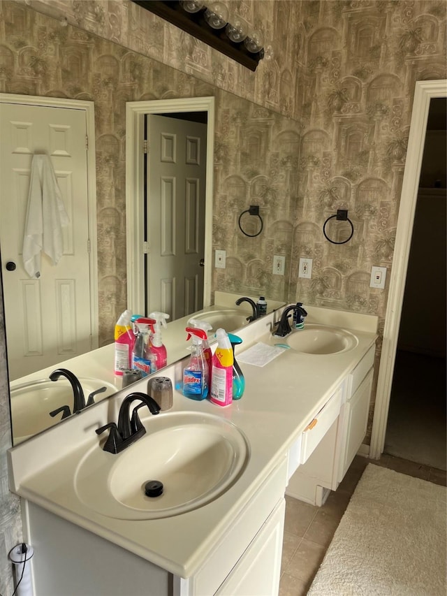 full bathroom with tile patterned flooring, wallpapered walls, and a sink