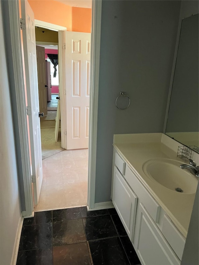 bathroom with vanity and baseboards