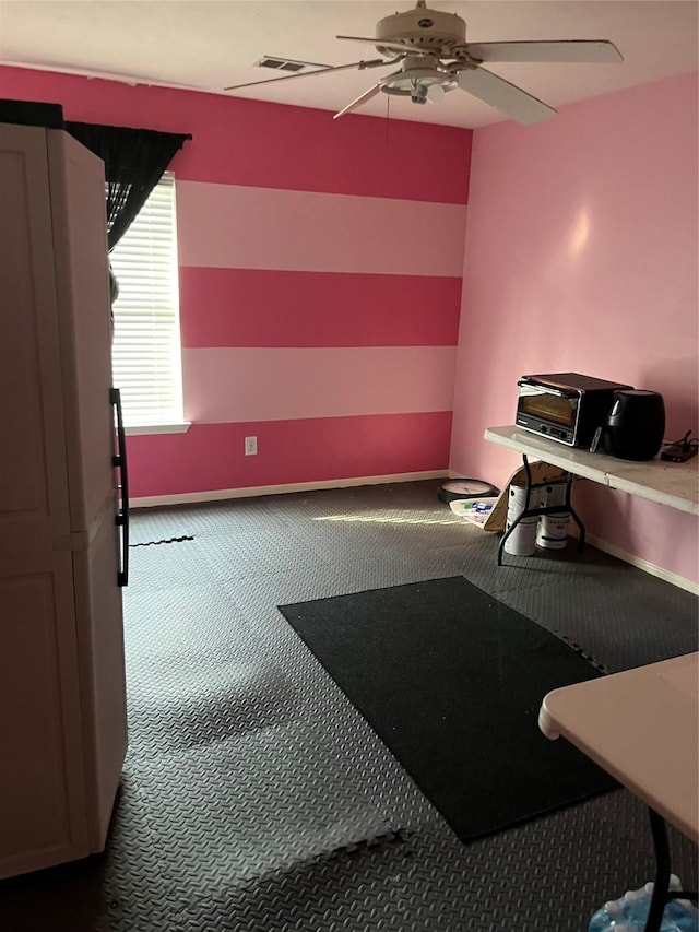 misc room featuring visible vents, baseboards, ceiling fan, and carpet floors