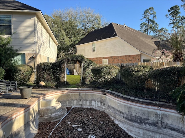 view of swimming pool featuring fence