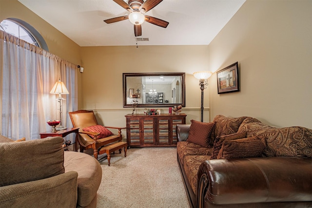 carpeted living area with visible vents and ceiling fan