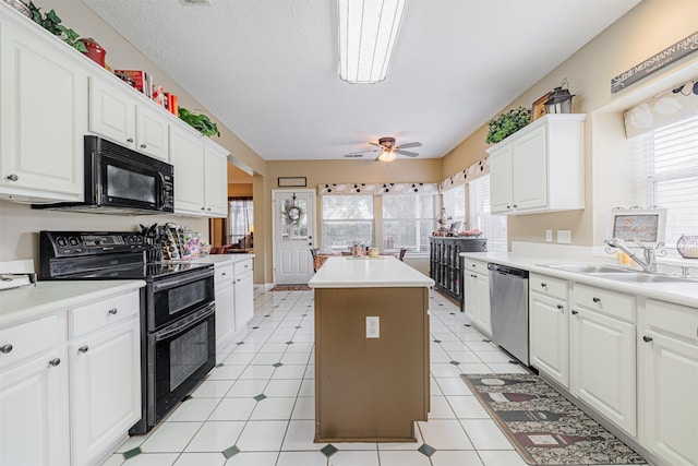 kitchen featuring a center island, black appliances, a wealth of natural light, and a sink