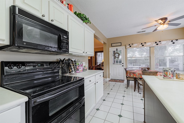 kitchen with visible vents, black appliances, white cabinets, light countertops, and a textured ceiling