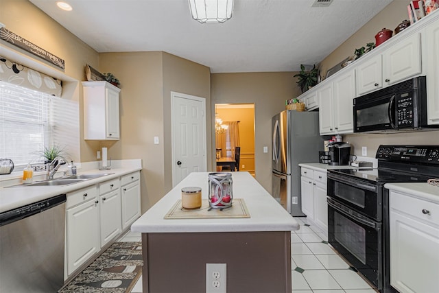 kitchen with white cabinets, black appliances, light countertops, and a sink