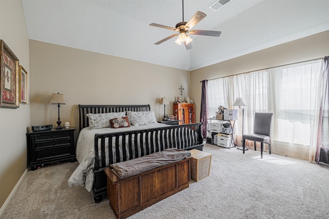 carpeted bedroom featuring visible vents, lofted ceiling, baseboards, and ceiling fan