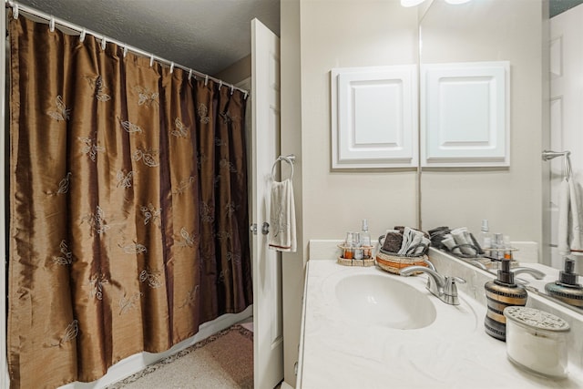 full bathroom featuring vanity, a shower with shower curtain, and a textured ceiling