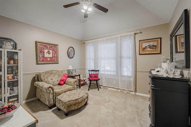 sitting room with baseboards, ceiling fan, carpet flooring, and vaulted ceiling