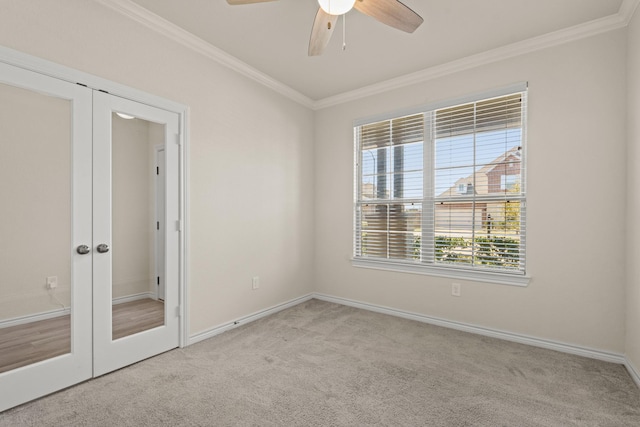 unfurnished bedroom featuring french doors, crown molding, baseboards, and carpet floors