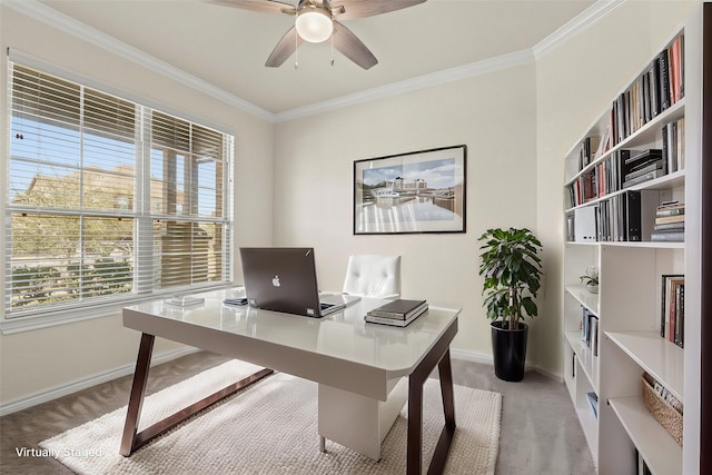 carpeted home office featuring ceiling fan, baseboards, and ornamental molding