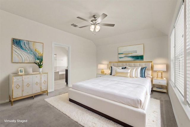 carpeted bedroom with ceiling fan, visible vents, lofted ceiling, and connected bathroom