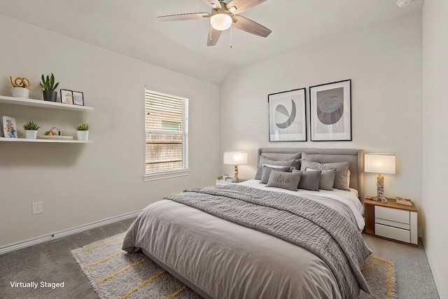 carpeted bedroom with lofted ceiling, baseboards, and ceiling fan