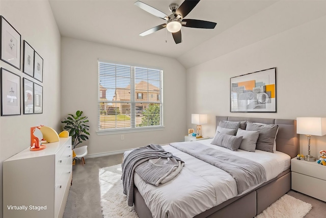 bedroom featuring baseboards, light carpet, lofted ceiling, and ceiling fan