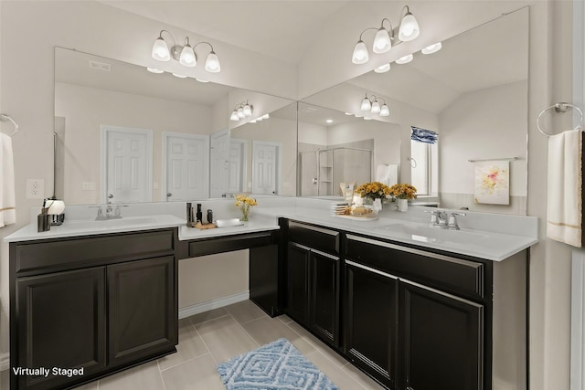 bathroom featuring tile patterned flooring, double vanity, a shower stall, and a sink