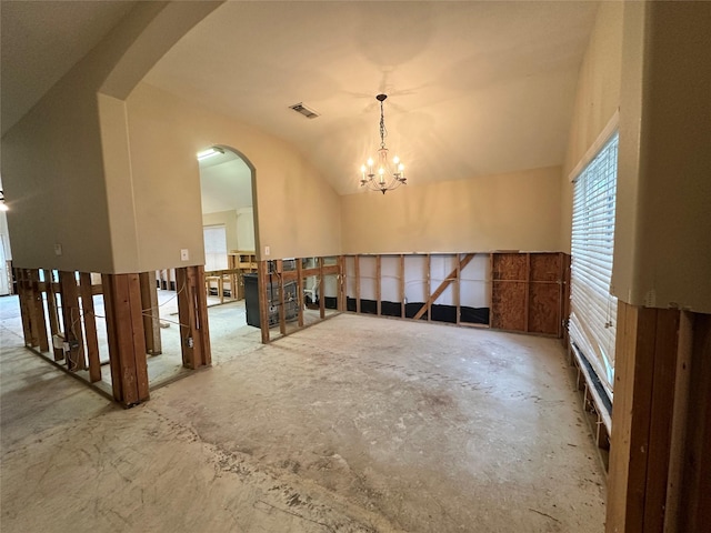 interior space featuring unfinished concrete floors, visible vents, arched walkways, vaulted ceiling, and a notable chandelier