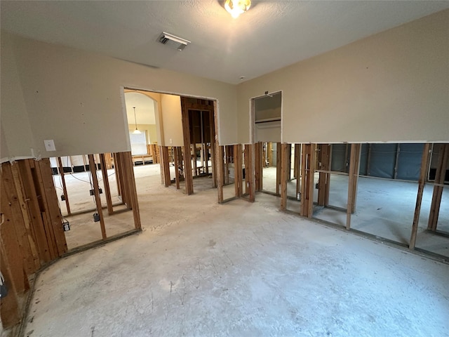 interior space featuring visible vents and unfinished concrete flooring