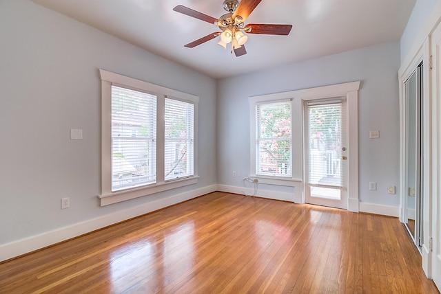 spare room with ceiling fan, baseboards, and light wood-style floors