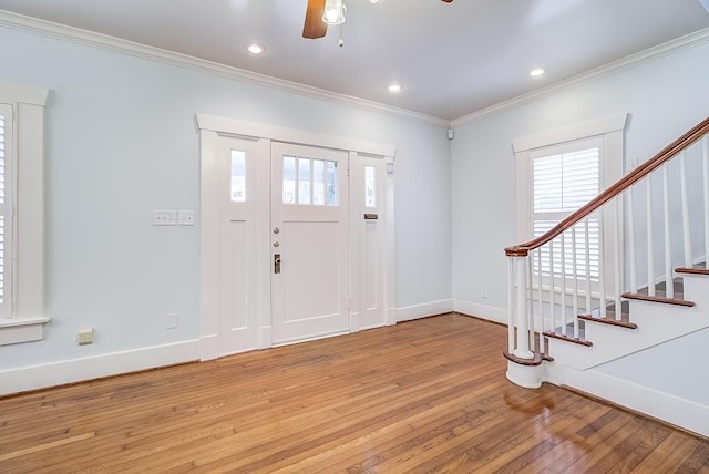 foyer featuring stairway, baseboards, recessed lighting, ornamental molding, and light wood-type flooring