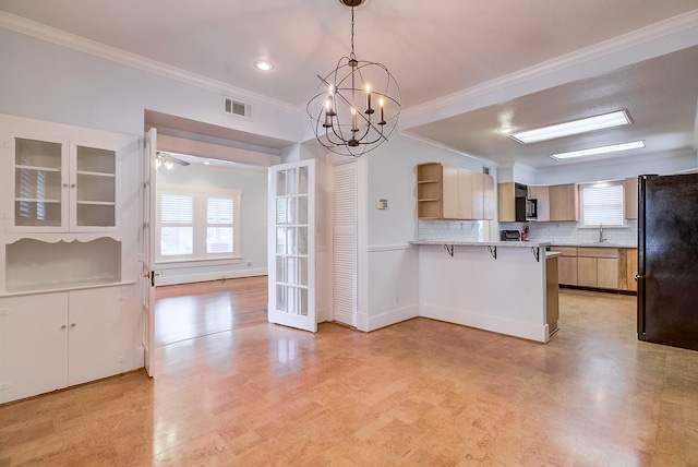 kitchen featuring a healthy amount of sunlight, a peninsula, freestanding refrigerator, and open shelves