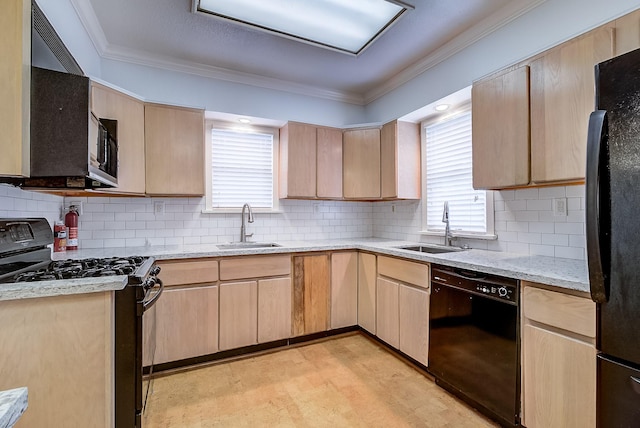 kitchen with a sink, black appliances, and light brown cabinetry