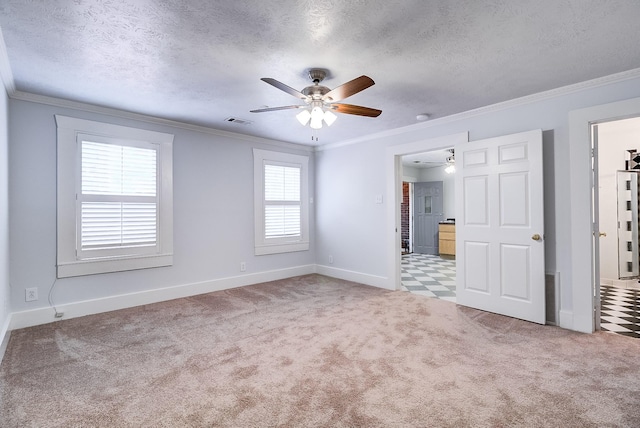 unfurnished bedroom with a textured ceiling, carpet, visible vents, and ornamental molding